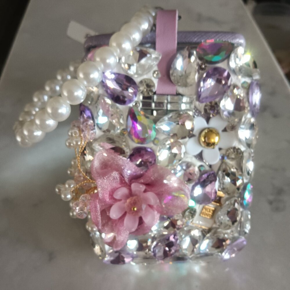 A crystal embellished two sided mirror with a pearl wristband and key hook